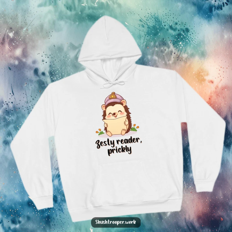 Funny Hoodie depicting a happy hedgehog wearing a cap, enthusiastically reading a tiny scroll, ideal for bookworms.