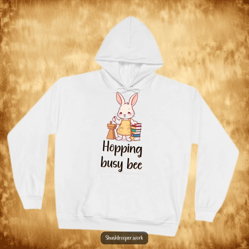 Funny bunny wearing an apron, efficiently stamping books with its paw, featured on a warm hoodie.